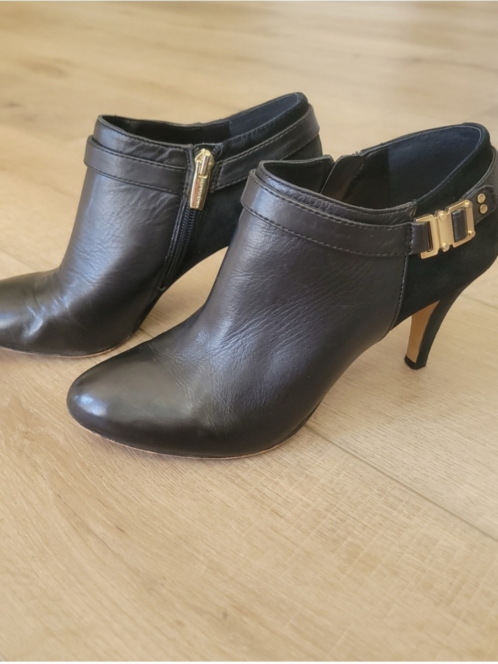 Vince Camuto Black Leather and Suede Heeled Ankle Booties with Gold Buckle.